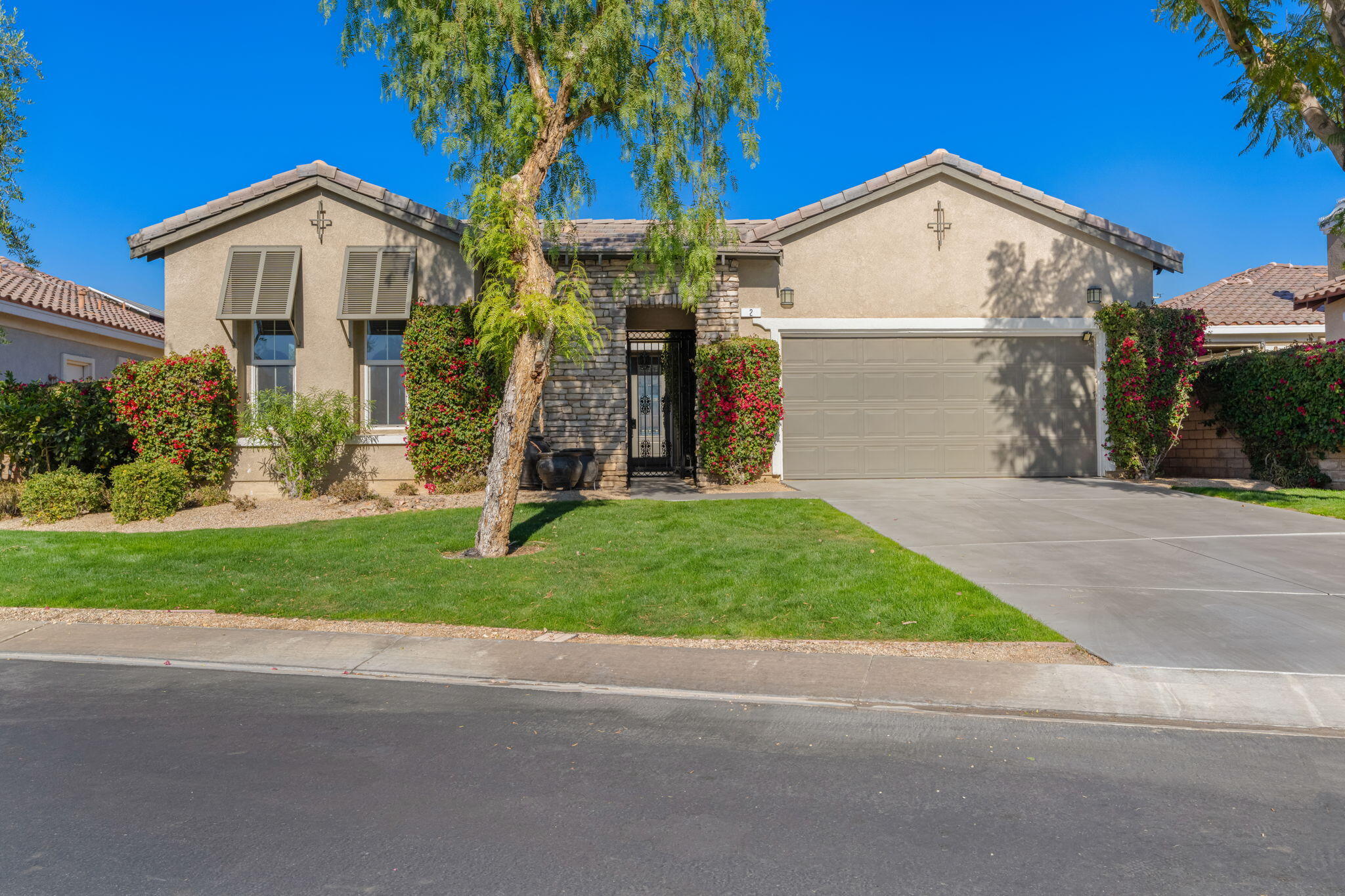 2 Pyramid Lake Court Rancho Mirage, CA 92270 - Photo 2 of 49 a front view of a house with a yard and garage