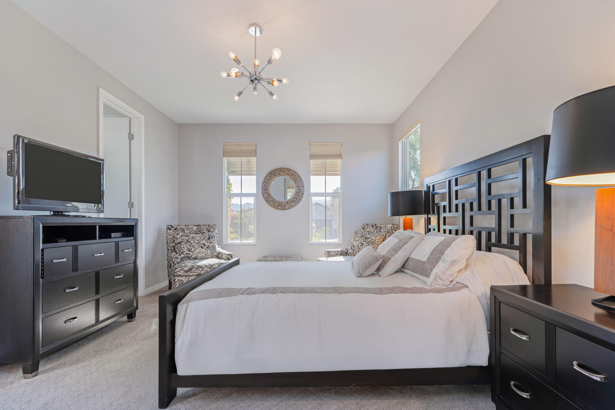 2 Pyramid Lake Court Rancho Mirage, CA 92270 - Photo 43 of 49 a bedroom with a large bed and a flat tv screen on a dresser