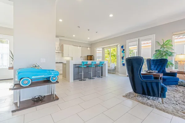 a kitchen with stainless steel appliances kitchen island granite countertop a refrigerator and a stove top oven