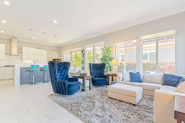 a kitchen with stainless steel appliances kitchen island granite countertop a refrigerator and a stove top oven