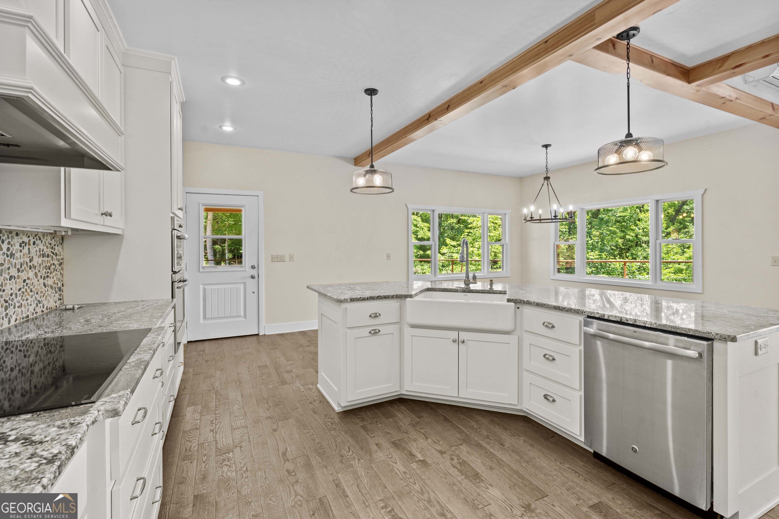 420 Hidden Acres Lane Clayton, GA 30525 - Photo 17 of 46 a kitchen with stainless steel appliances granite countertop a sink a stove and a wooden floors