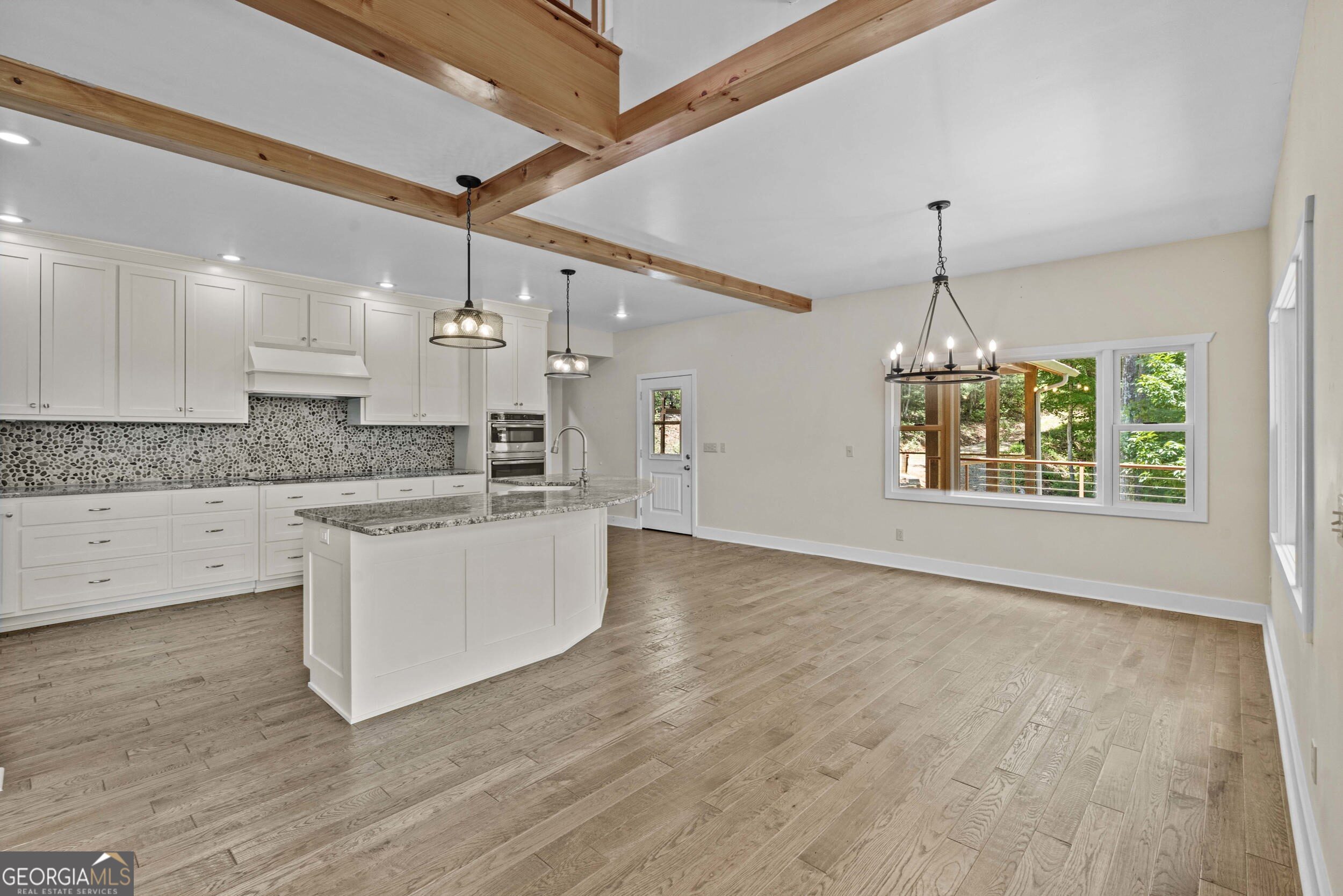 420 Hidden Acres Lane Clayton, GA 30525 - Photo 19 of 46 a large kitchen with cabinets wooden floor and a chandelier
