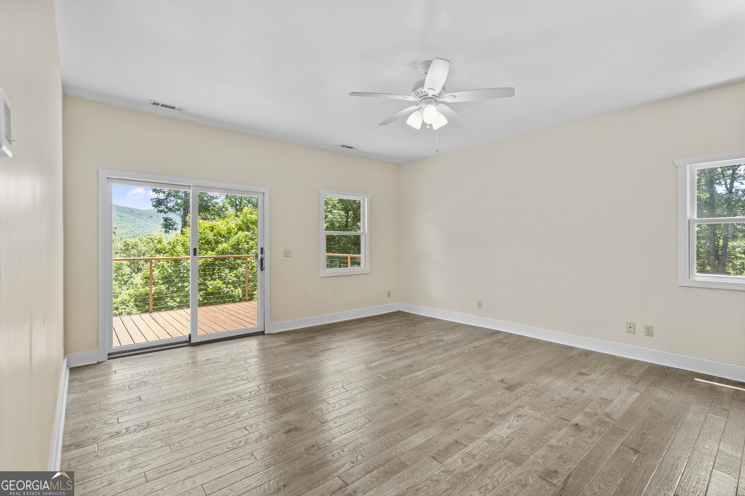 420 Hidden Acres Lane Clayton, GA 30525 - Photo 21 of 46 an empty room with wooden floor fan and windows