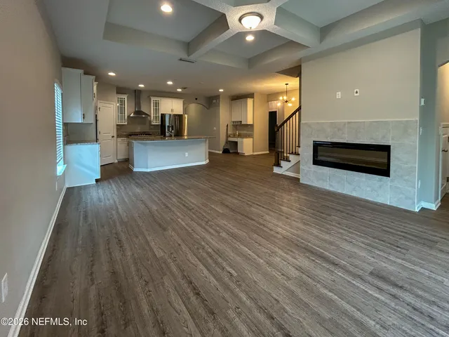 a view of a kitchen with a sink and a refrigerator