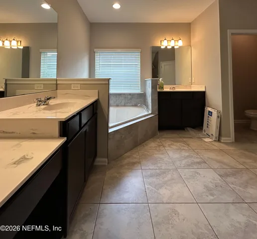 a view of kitchen with granite countertop a sink and cabinets