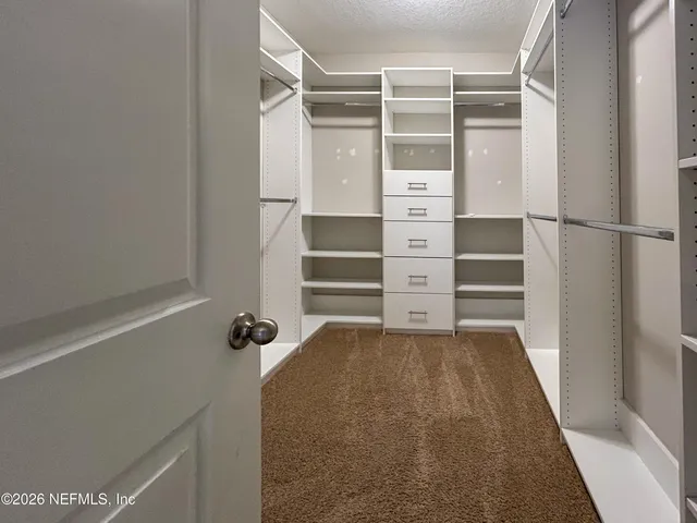 a view of an empty walk in closet