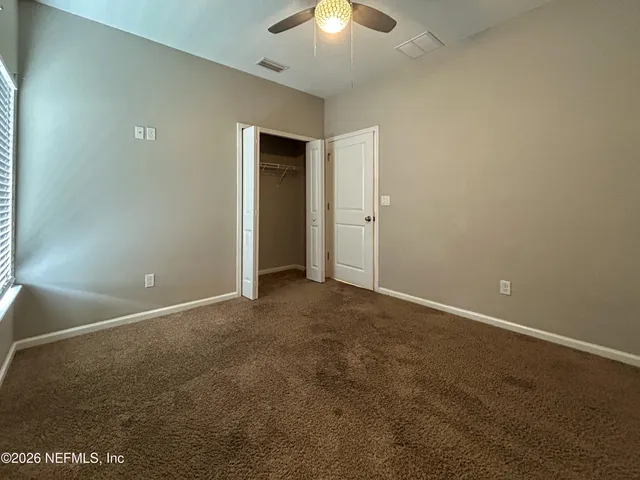 a view of empty room with ceiling fan