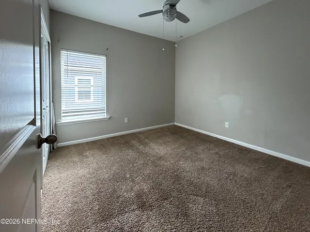 a view of an empty room with a large window