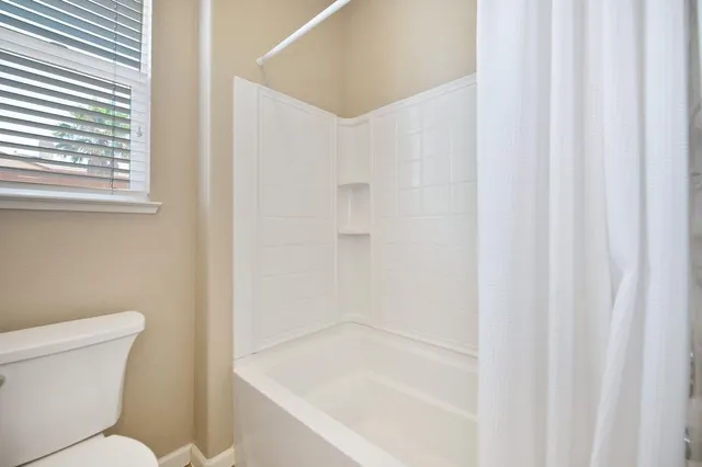 a bathroom with a toilet and a bathtub