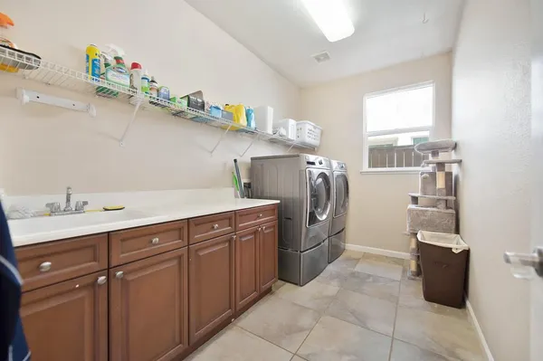 a utility room with cabinets dryer and washer