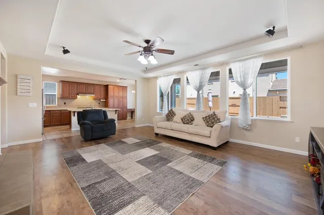 a living room with furniture and wooden floor