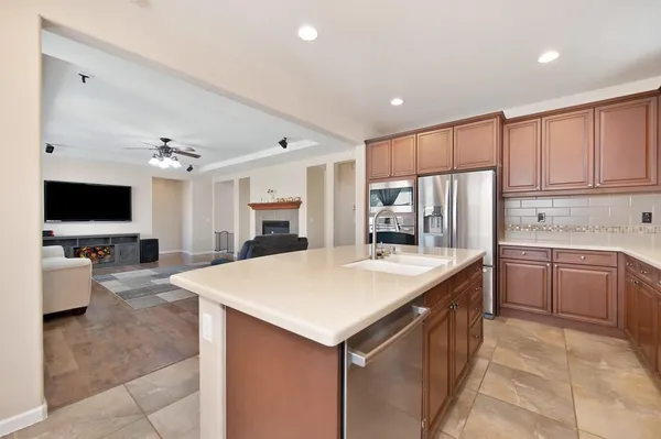 a large kitchen with a large counter top appliances and cabinets