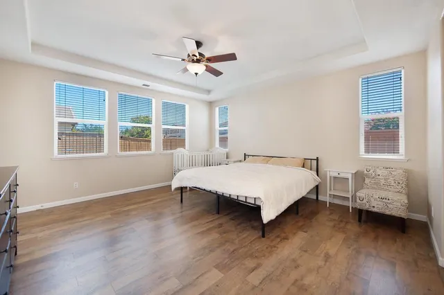 a bedroom with a bed and wooden floor