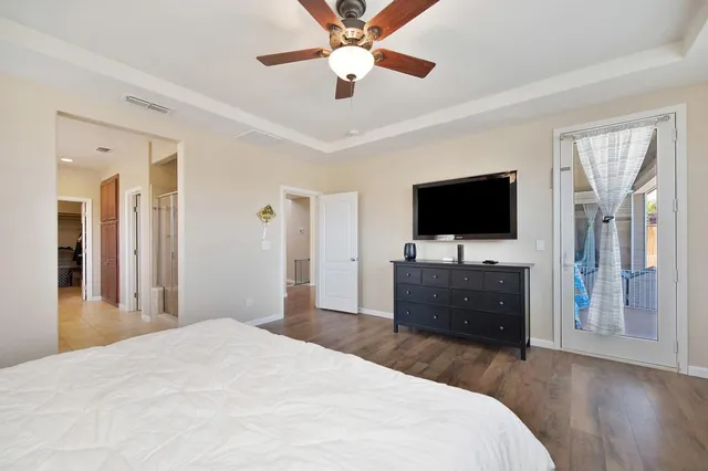 a bedroom with a bed and a flat screen tv