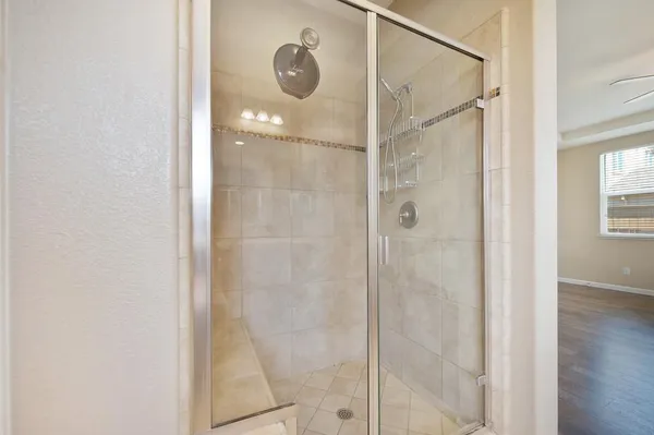 a bathroom with a glass shower door
