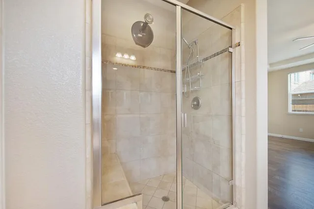 a bathroom with a glass shower door