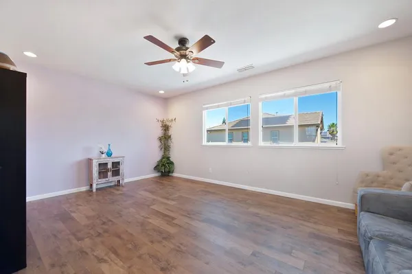 a view of a livingroom with a ceiling fan and window