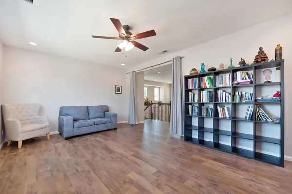a living room with furniture and a wooden floor