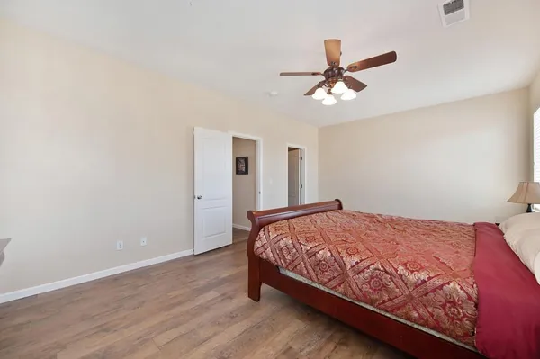a bedroom with a bed and a ceiling fan