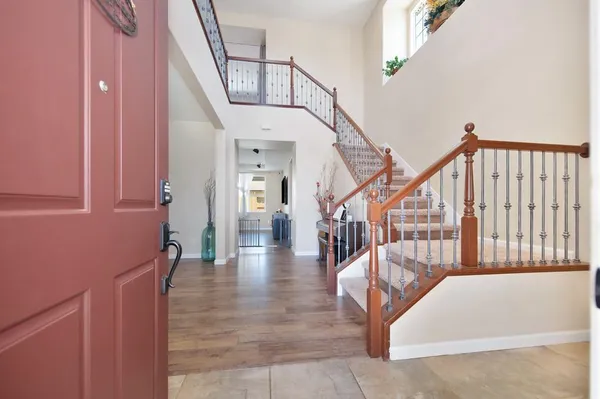 a view of entryway and hall with wooden floor