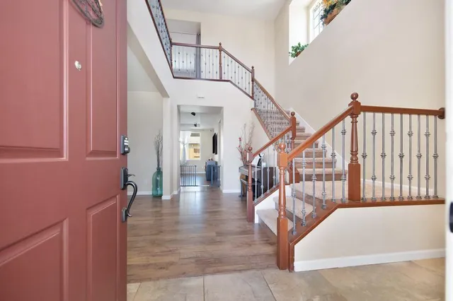 a view of entryway and hall with wooden floor