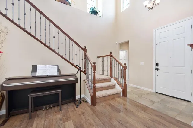 a view of staircase with wooden floor and a fireplace