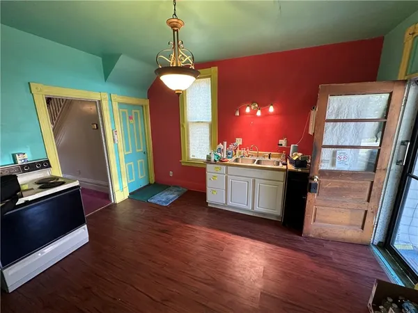 a kitchen with a refrigerator and a stove top oven