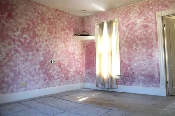 a view of a hallway with a chandelier fan and windows