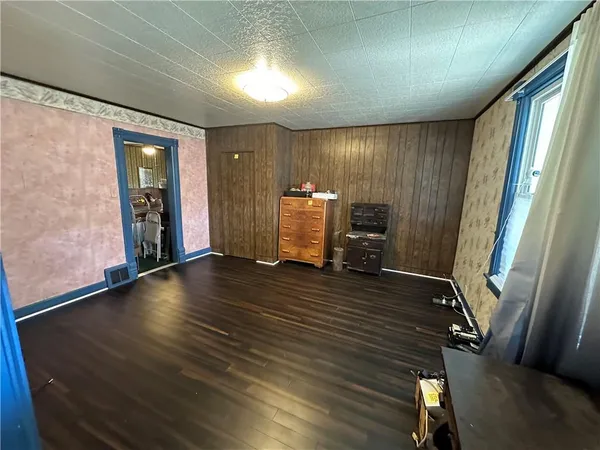 wooden floor in an empty room with a window