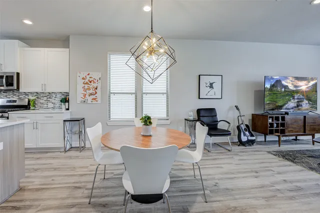 a living room with dining room and wooden floor