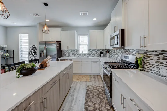 a kitchen with a sink stove and cabinets