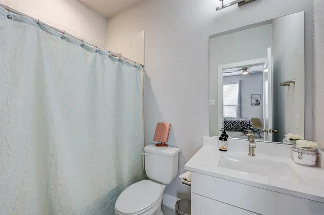 a bathroom with a sink a mirror and a toilet