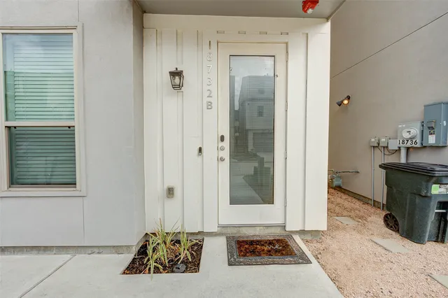 a view of a building with a lot of windows and couches chairs