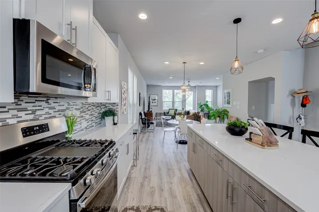 a kitchen with counter top space a sink stainless steel appliances and cabinets