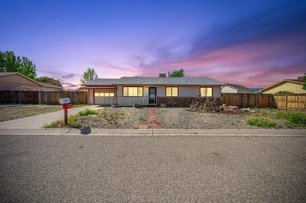 front view of a house next to a yard