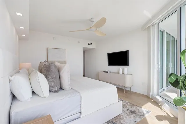 a bedroom with a bed and a flat screen tv