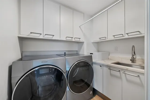 a utility room with sink dryer and washer