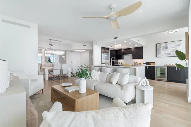 a living room with furniture and kitchen view