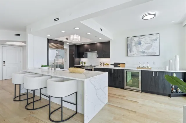 a kitchen with stainless steel appliances kitchen island granite countertop a sink and cabinets