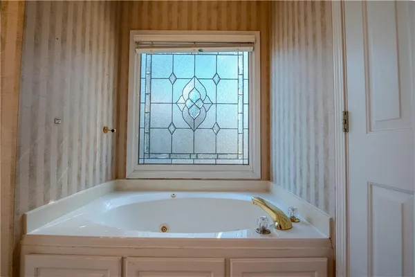 a white bath tub sitting next to a window