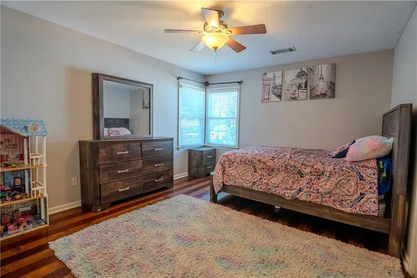 a bedroom with a bed and a dresser in it