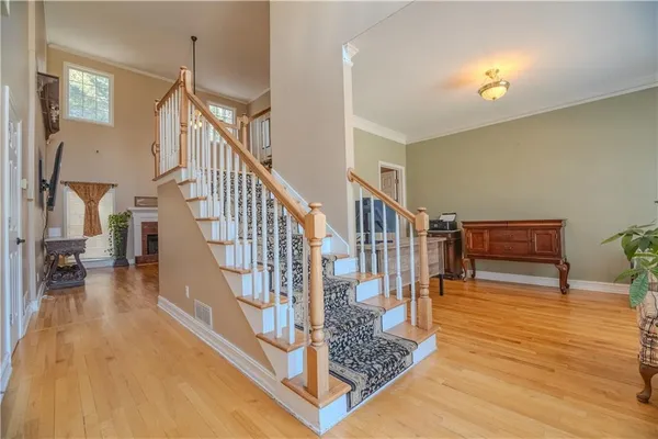 a view of entryway and hall with wooden floor