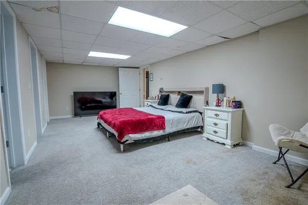 a bedroom with a bed and a chair