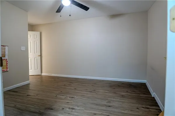a view of an empty room with wooden floor