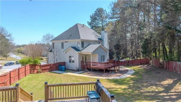 a view of a house with pool and chairs