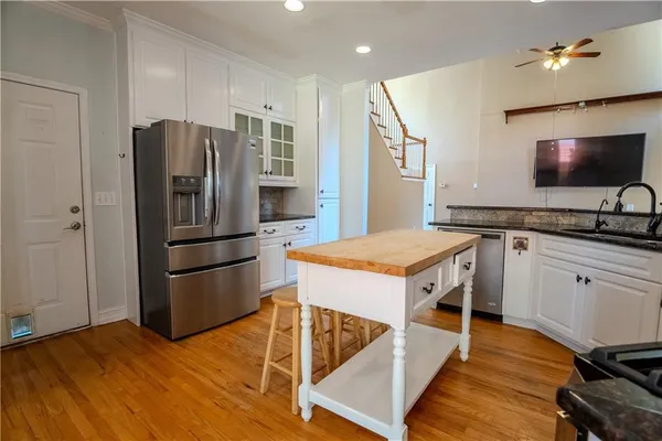 a kitchen with a sink refrigerator and microwave