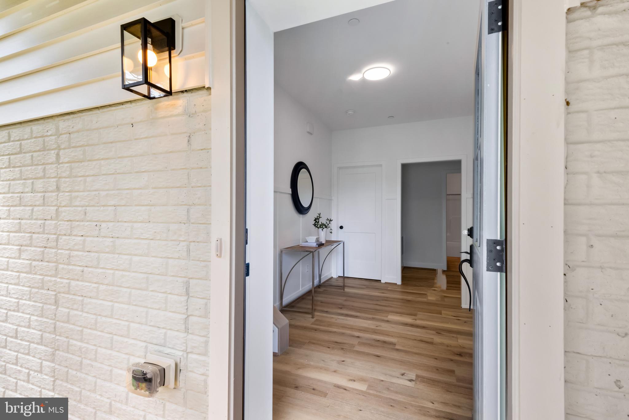 6016 Drum Point Road Deale, MD 20751 - Photo 2 of 42 a view of a hallway with wooden floor and staircase