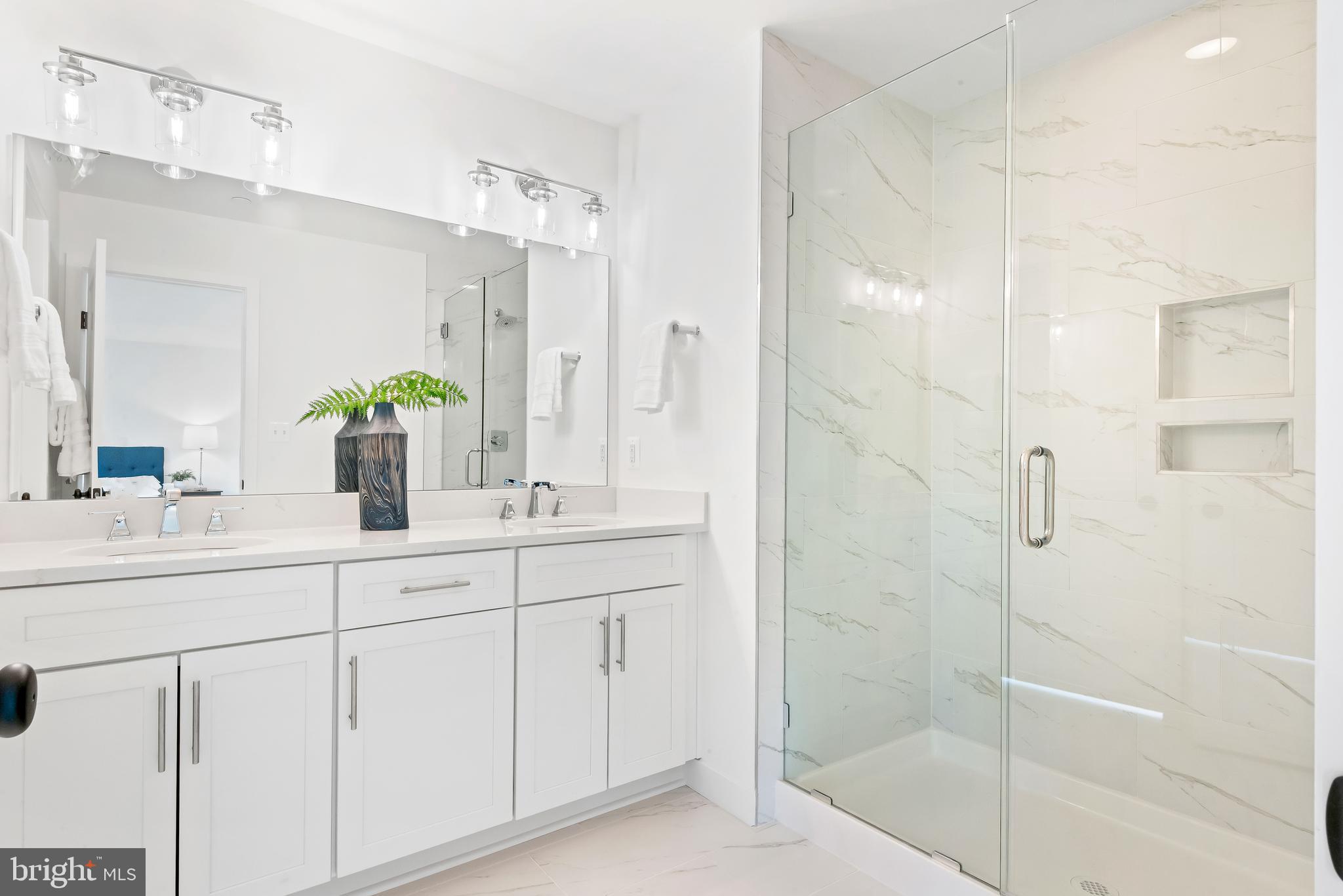 6016 Drum Point Road Deale, MD 20751 - Photo 29 of 42 a bathroom with a shower sink and mirror