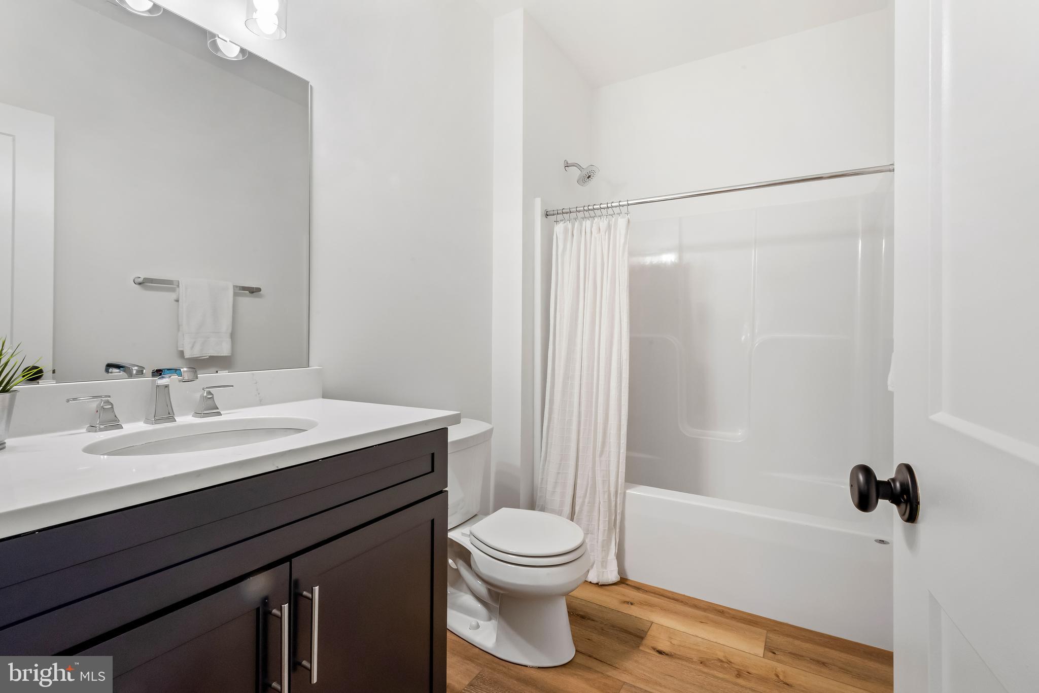 6016 Drum Point Road Deale, MD 20751 - Photo 34 of 42 a bathroom with a sink a toilet and shower