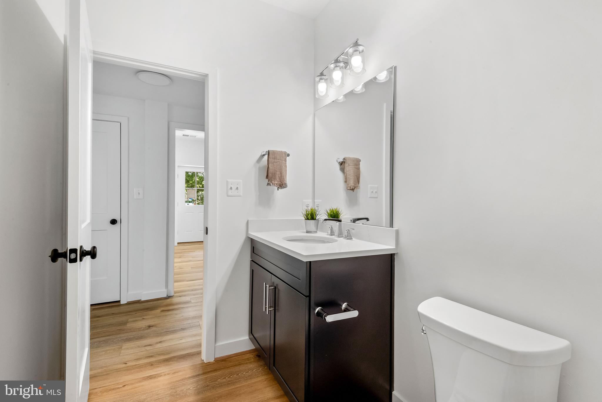 6016 Drum Point Road Deale, MD 20751 - Photo 35 of 42 a bathroom with a sink a toilet and mirror